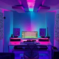 a music studio with colorful lights and a desk